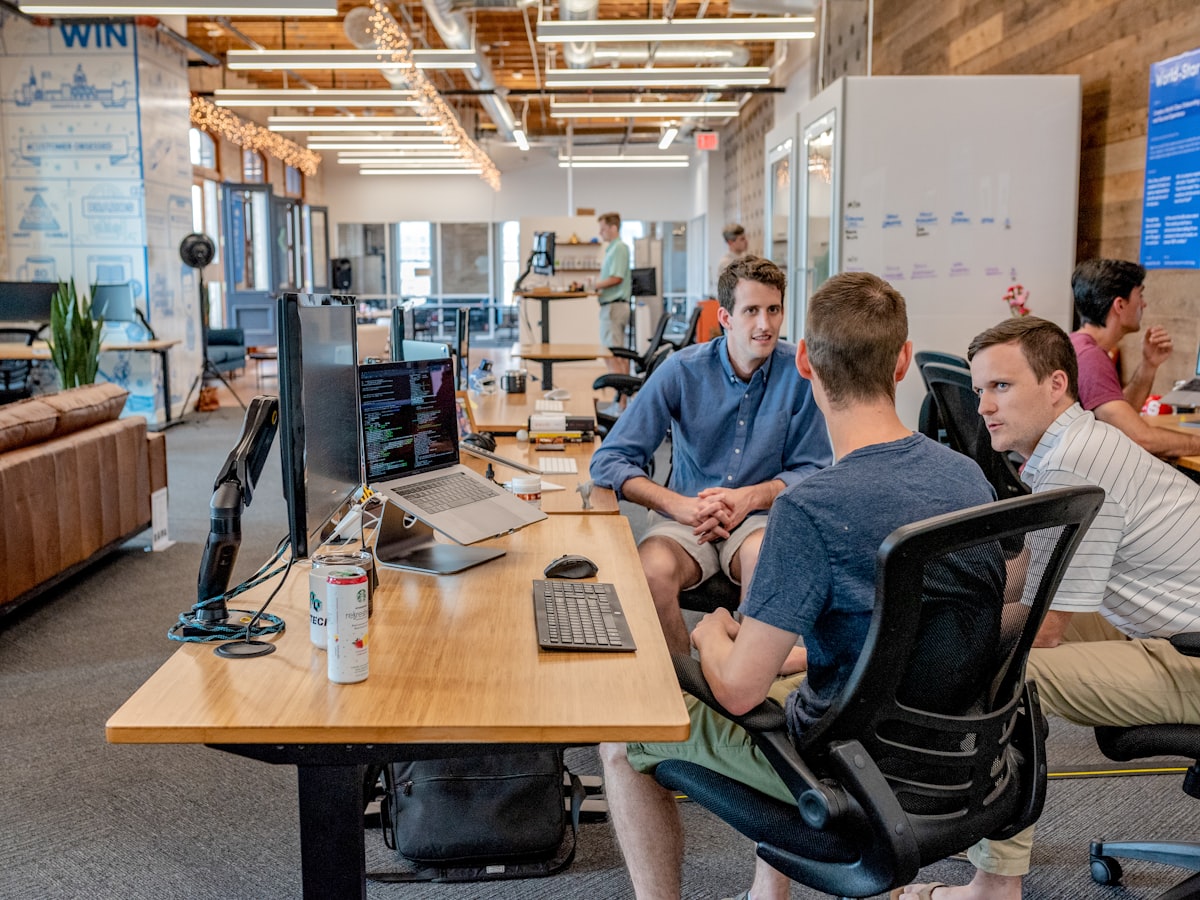 A small team reviewing day-to-day operations together at a desk.