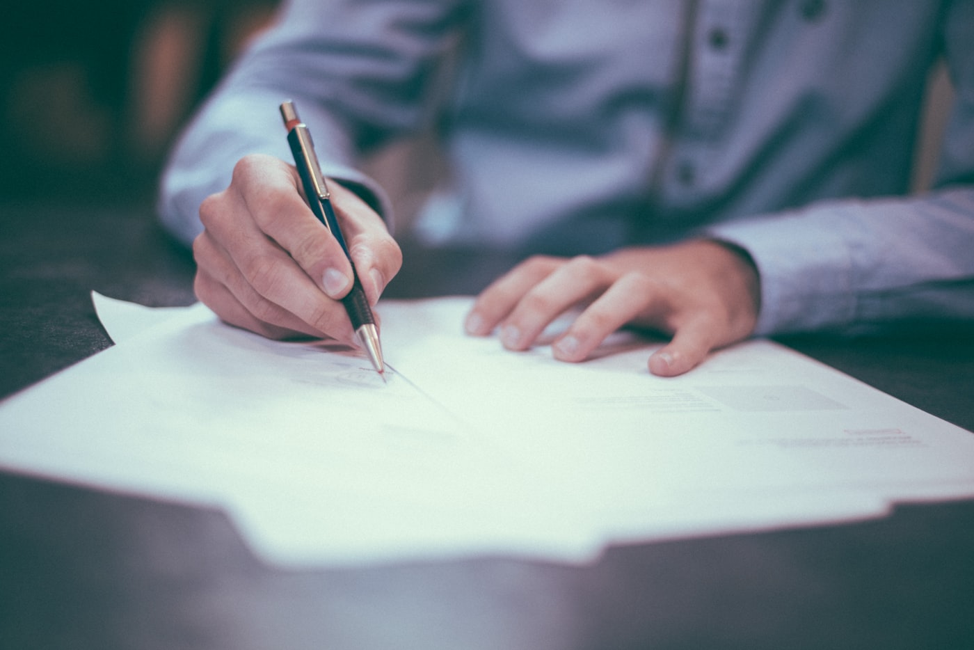 Signing official business registration documents.
