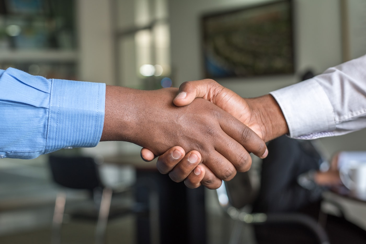 A handshake sealing an ongoing advisory partnership.